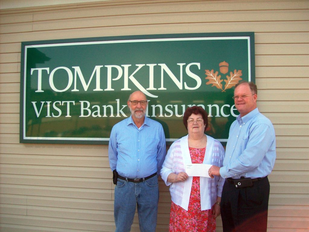 Tompkins Vist Bank presents funds to the Schuylkill County Fair which will provide assistance in keeping the gate admission at a very affordable level for all who attend the Fair August 1 through the 6. Pictured are from left, Charlie Kershner, entertainment booking agent for SCF, Grace Karrer, SCF Entertainment Chairman and Joe Hammond, Vice President for Tompkins Vist Bank.